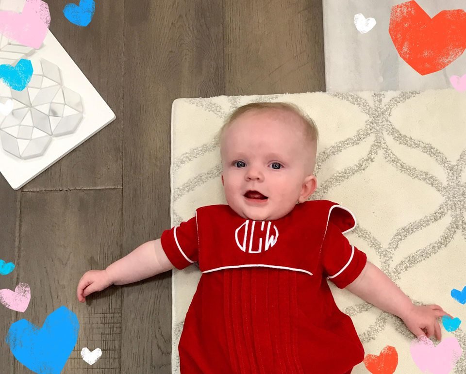 Beautiful child in red staying on the carpet floor from Expressway Carpet in Mobile, AL