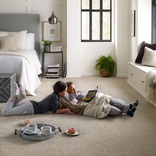boy and girl reading on the brown carpet floor from Expressway Carpet in Mobile, AL