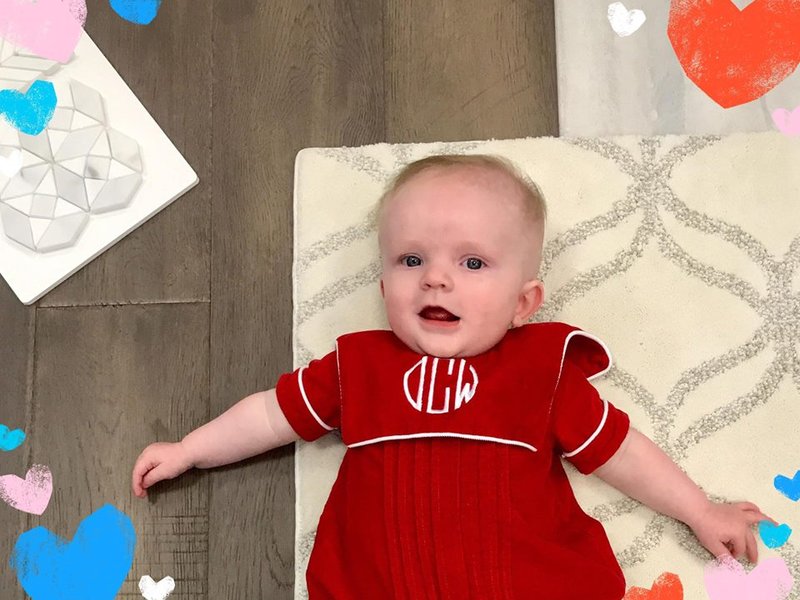 Beautiful child in red staying on the carpet floor from Expressway Carpet in Mobile, AL